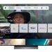 Uma Smart TV LG OLED moderna numa sala minimalista, a exibir a interface da aplicação MEO TV integrada, sem box ou cabos visíveis.