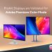 Monitor ASUS ProArt Display OLED PA27UCDMR sobre secretária de edição profissional com interface do Adobe Premiere aberta em modo HDR com paleta de cores calibrada visível