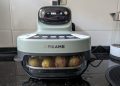 Dreame Tasti Glass Air Fryer em vidro de borossilicato transparente sobre bancada de cozinha branca com recipiente interior visível