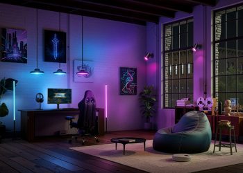 Monitor gaming Philips Evnia com iluminação Ambiglow activa a projectar cores para a parede circundante num quarto de gaming em ambiente escuro